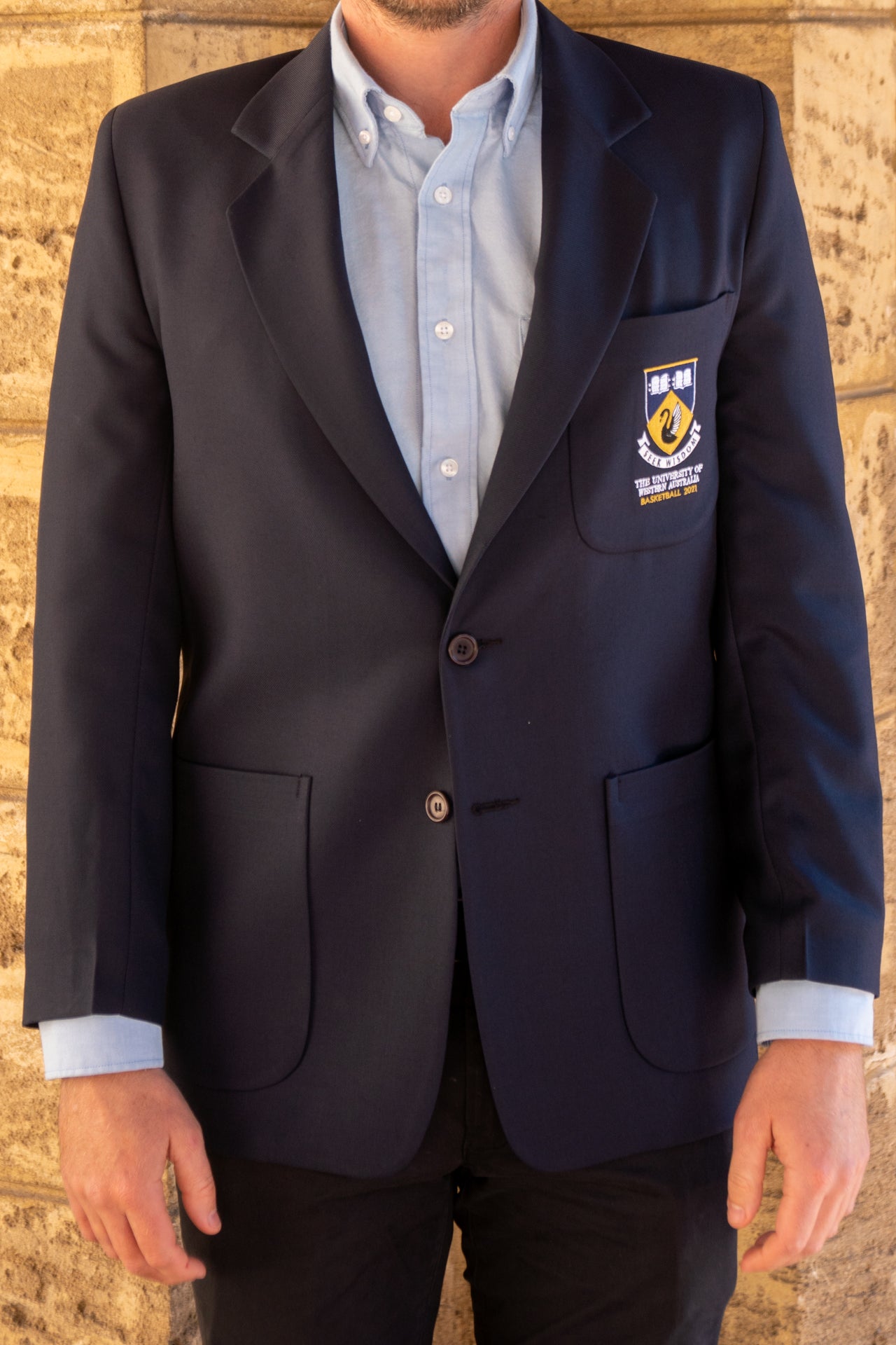 A front view of a man wearing the UWA Blues Blazer.